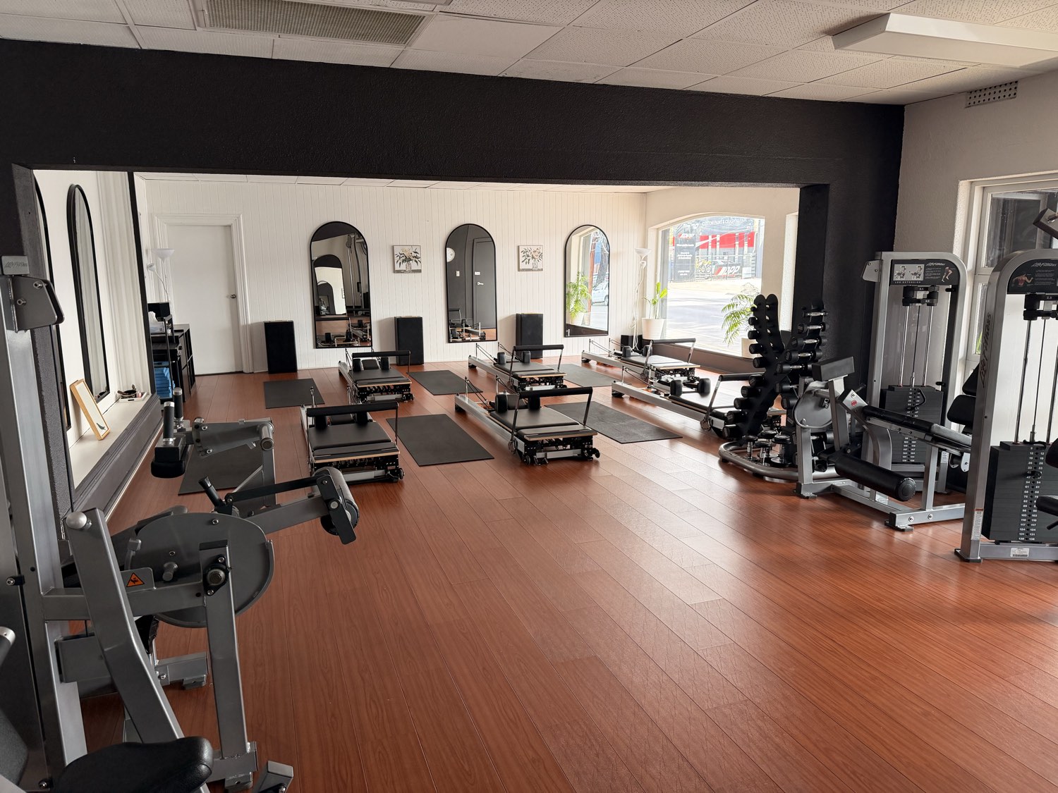 The studio at 32 Magill Road: a strength machine in the foreground and the Reformers behind it, on one continuous floor.